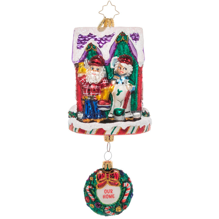 Back - Ornament Description - The Claus' Fixer Upper: Santa works hard all year building toys, so he knows all about manual labor. This ornament features Santa and Mrs. Claus fixing up their house – perfect for the handy new homeowner.