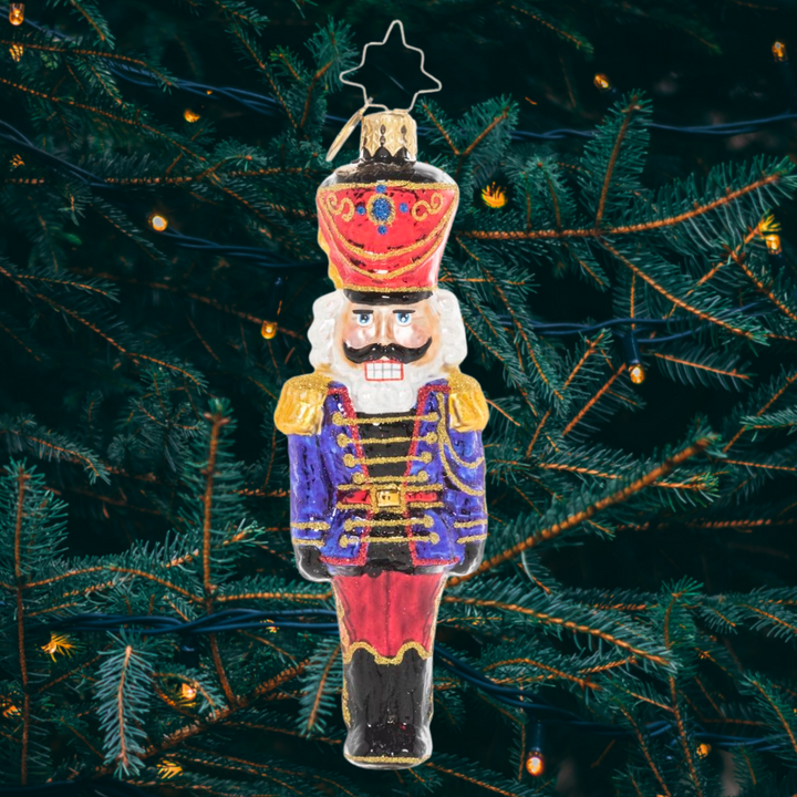 Ornament Description - Classic Christmas Nutcracker: At ease, soldier! A classic mustachioed nutcracker looks smart in his Christmas uniform, ready to keep watch over your tree.