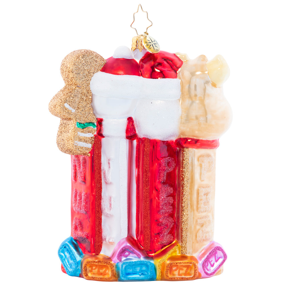 Back - Ornament Description - North Pole PEZ: Santa, his faithful reindeer, a jolly snowman, and a cheery gingerbread man join together in this charming piece that celebrates two of the things that help make the holiday season so sweet: good company, and delicious PEZ candies!