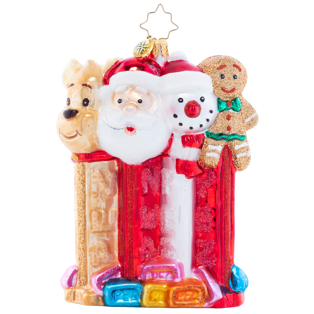 Ornament Description - North Pole PEZ: Santa, his faithful reindeer, a jolly snowman, and a cheery gingerbread man join together in this charming piece that celebrates two of the things that help make the holiday season so sweet: good company, and delicious PEZ candies!