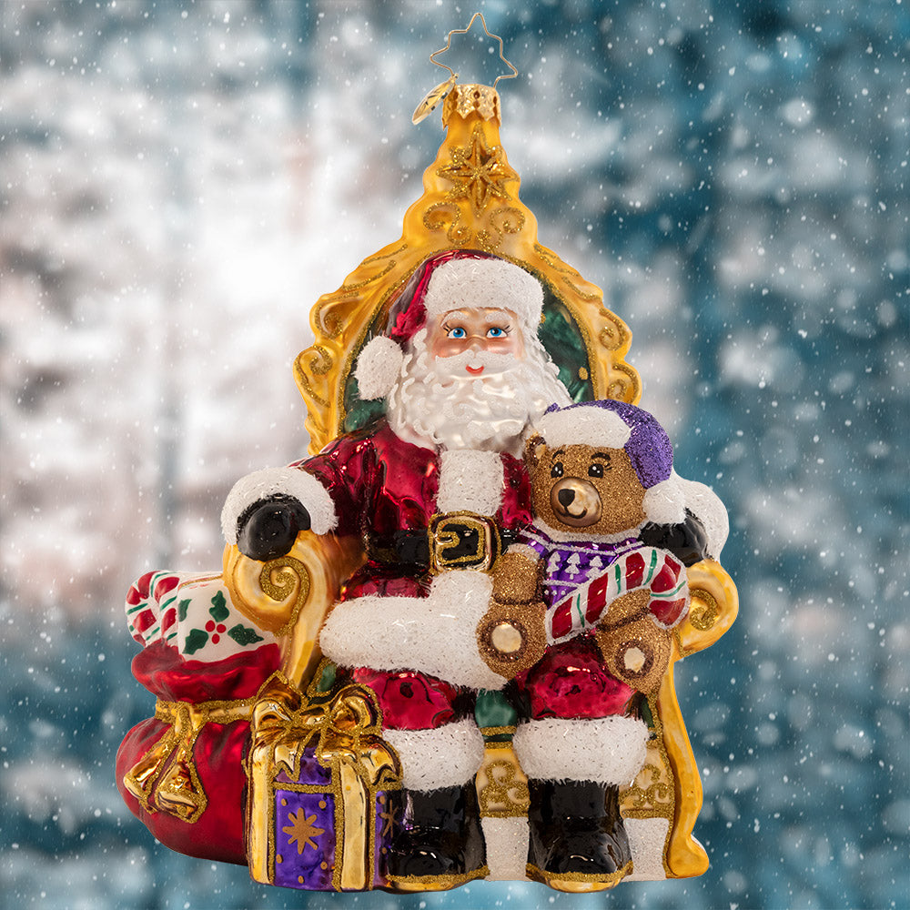 Ornament Description - Strike A Pose Santa: Perfectly poised in a comfy chair surrounded by gifts, Santa is ready to listen to the Christmas wish lists from the good little girls and boys.