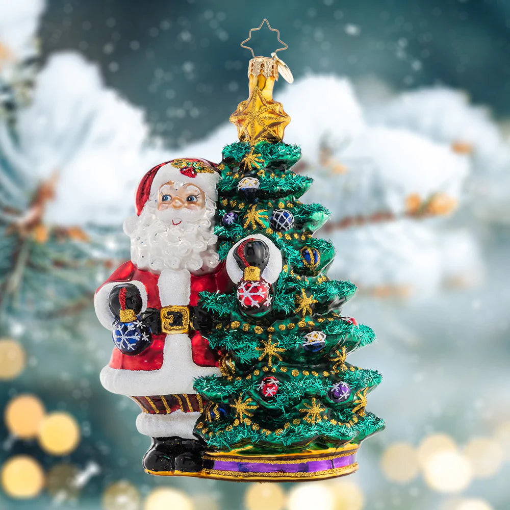 Ornament Description - Deck the Halls Santa: Santa is ready to show off his extensive ornament collection as he trims his Christmas tree with beautiful glass baubles.