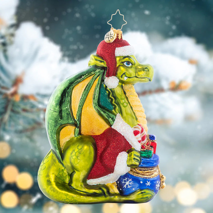 Ornament Description - Fire-Breathing Friend: Never fear, this majestic green dragon is only here to spread Christmas cheer! He's an absolutely resplendant reptile in a red coat and festive Santa hat.