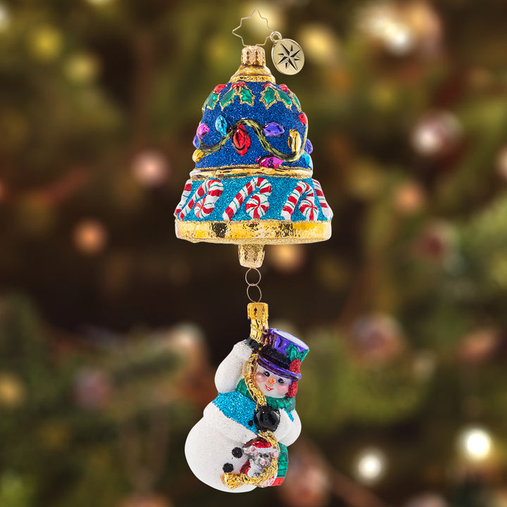 Ornament Description - Frosty Ringer: Dangling delicately from a beautiful blue Christmas bell, this little snow friend is ready to ring in Christmas! Adorned with colorful lights and candycanes, this piece is truly a treat to behold.