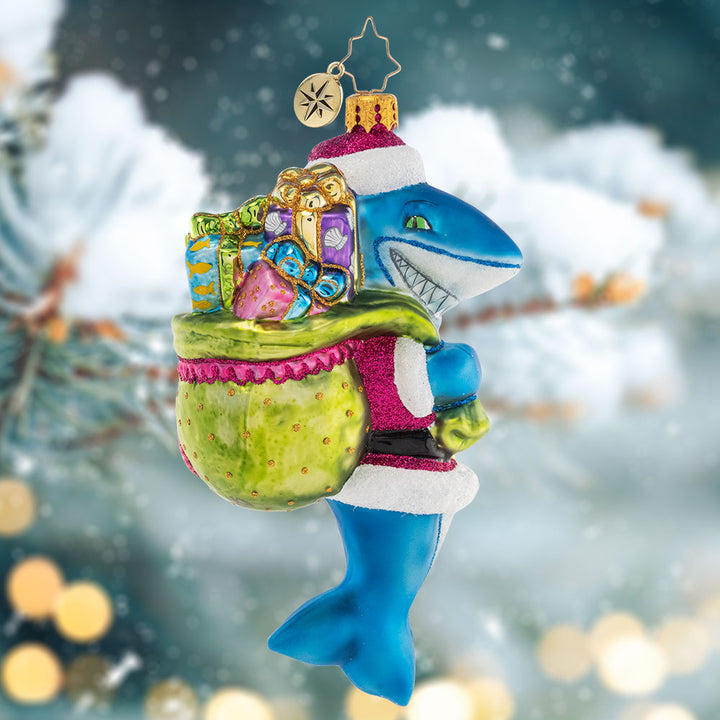 Ornament Description - Santa Jaws: Shining and smiling with a bag full of gifts, this jolly Santa-Jaws ornament is nothing to be afraid of! He's spreading Christmas cheer all across the deep blue sea with his bounty of presents.