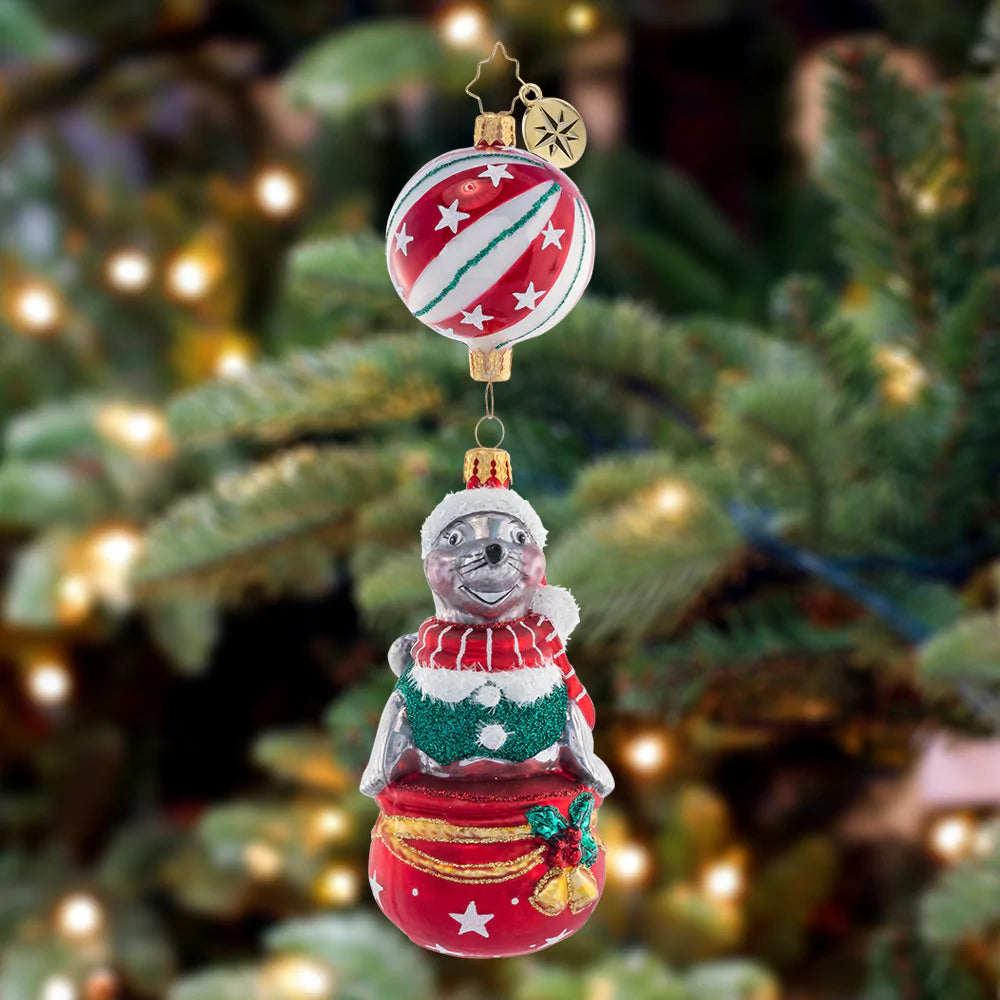 Ornament Description - It's A Seal-abration: This seal donning a Santa hat can be the star of the show on your tree this year. Perfectly balanced, he won't drop the ball!
