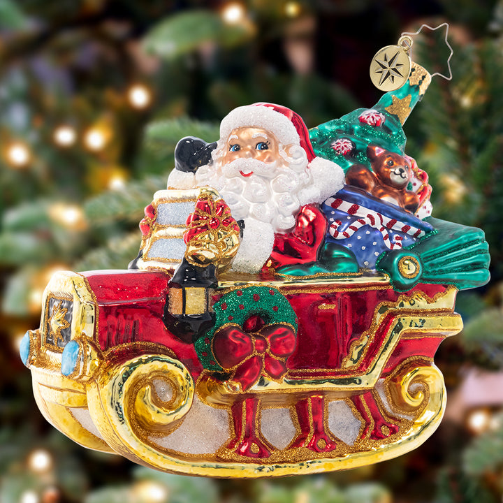 Ornament Description - Ready to Ride Santa: Beep beep! Santa's droptop sleigh-mobile is modeled after a vintage car. He'll have no problem getting through the snowy night in this sweet ride!