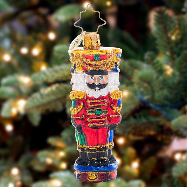 Ornament Description - Three Nutty Knights Gem: Standing guard in red, blue, and green, these stylish and stoic nutcrackers have each other's backs – the perfect protectors for the gifts under your Christmas tree!