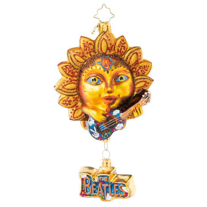 Ornament Description - The Beatles' Sun King: The sun is up, the sky is blue, and this mystical musician has a tune for you. Across the universe, his sweet song rings out, making the whole world twist n' shout. And before he sets, he pleads, "remember: love is all you need."