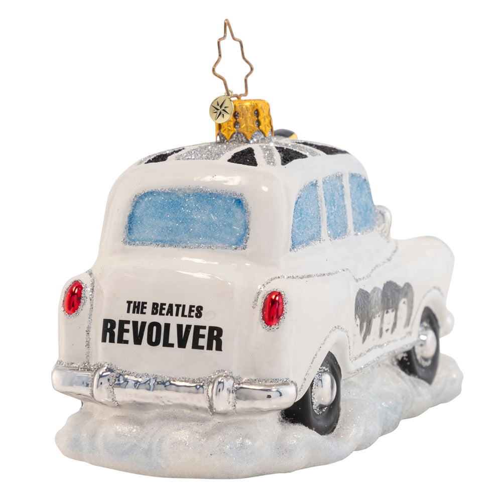 Back View - Ornament Description - The Beatles' Roving Revolver Taxi: The show's tonight, and the The Fab Four are running behind. Hightail it, cabbie, they're on in 5! Through the London streets they race, arriving to the stage door with a feverish pace. The lights go dim, the fans all flock. Just as the curtains open, Paul shouts,"are you ready to rock?"