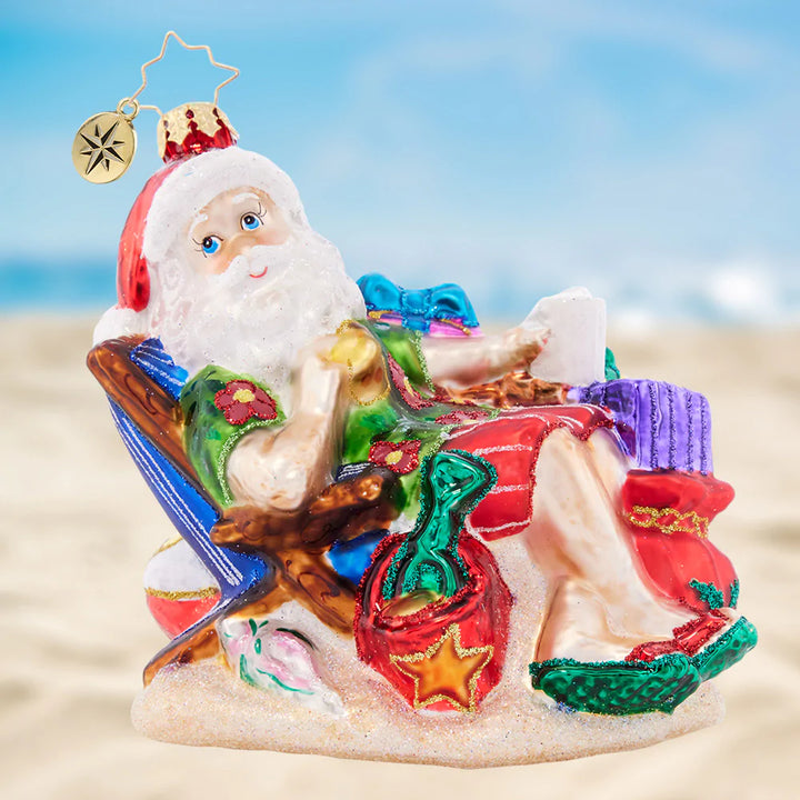 Ornament Description - Beach Bum Santa: Santa is kicking his feet up and watching the waves for a post-holiday vacay. The North Pole is pretty chilly this time of year, so he's excited for surf and sun with a little Christmas fun!