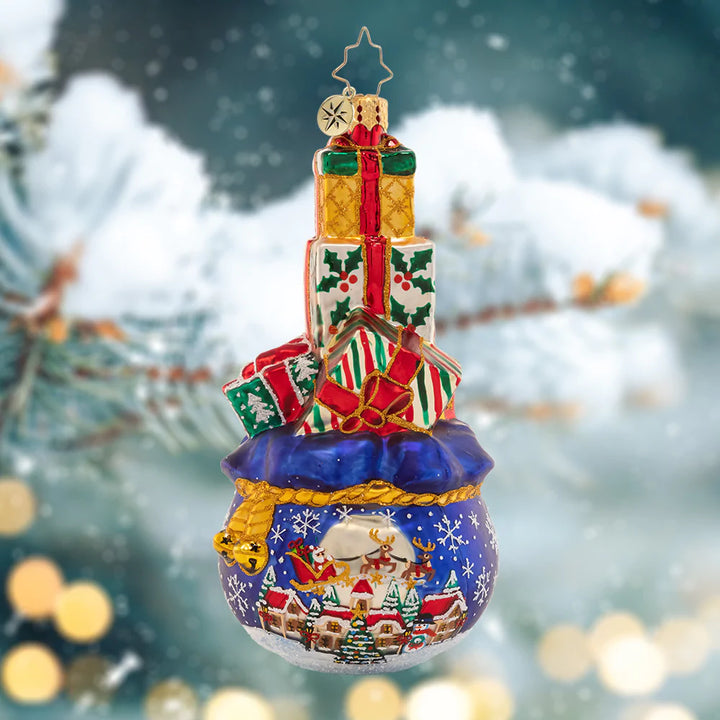 Ornament Description - Gift Delivery: This tower of good tidings is full to the brim with Christmas presents. Looks like there were lots of good little girls and boys on the nice list this year!