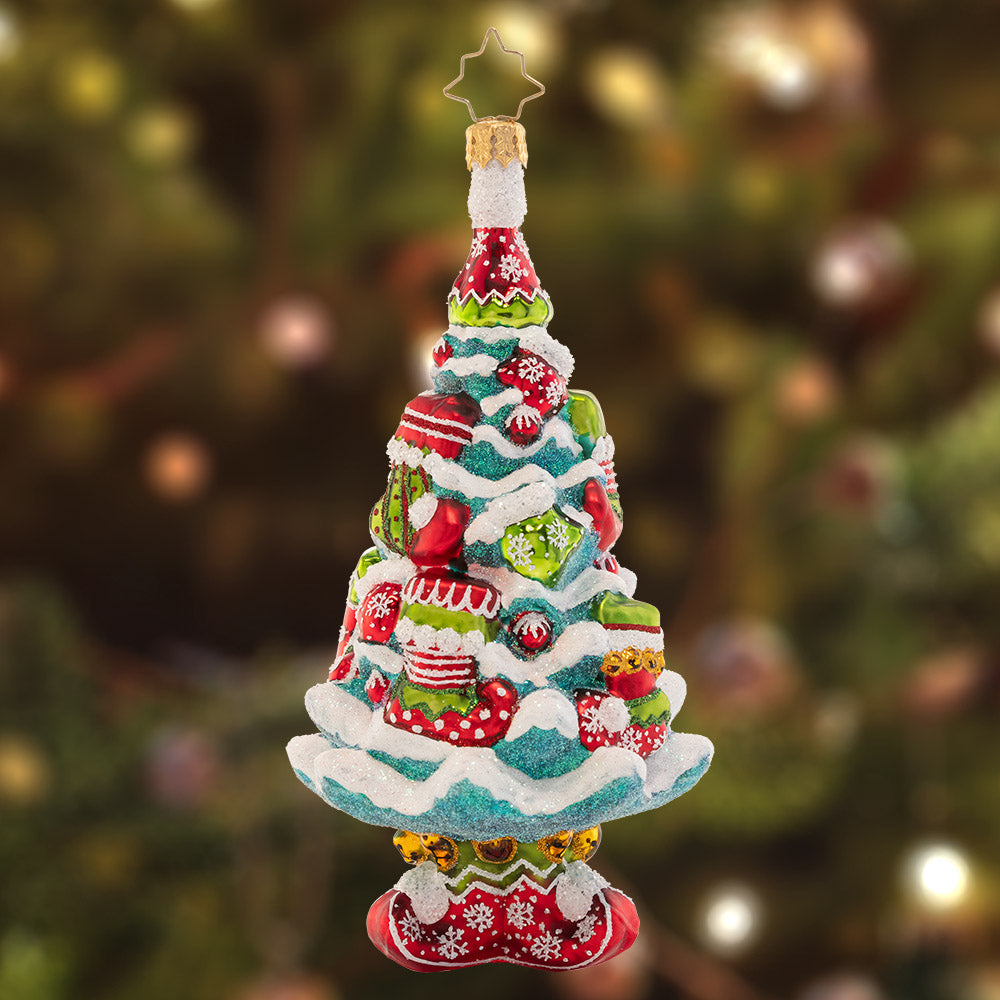 Ornament Description - Santa's Helpers Tree: Tastefully trimmed in elfin stockings and boots, this cheerful Christmas tree is the perfect place to showcase Santa's gifts! Afterall, his helpers did build the toys…
