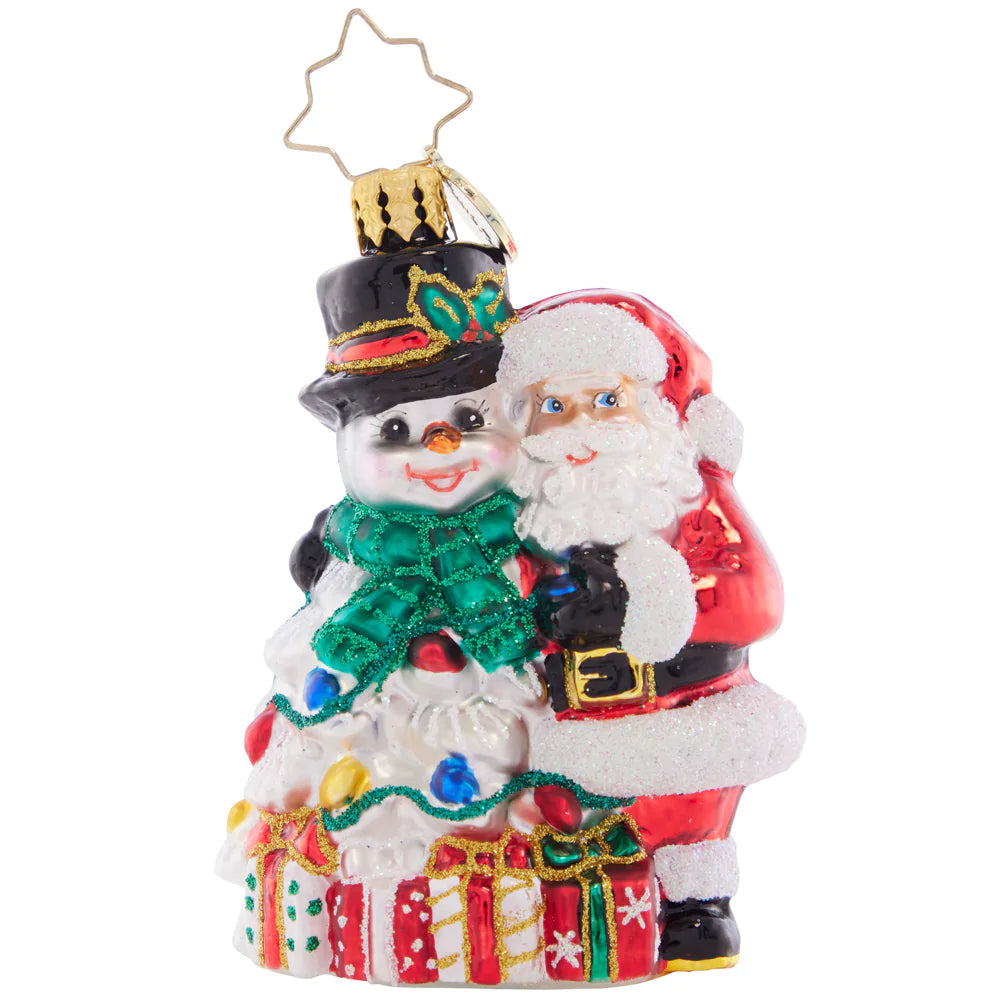 Front - Ornament Description - A Frosty Duo Gem: The smiling Santa and Snowman are a perfect holiday pair, surrounded by beautifully-wrapped gifts and Christmas lights. 'Tis the season for festive friendship!