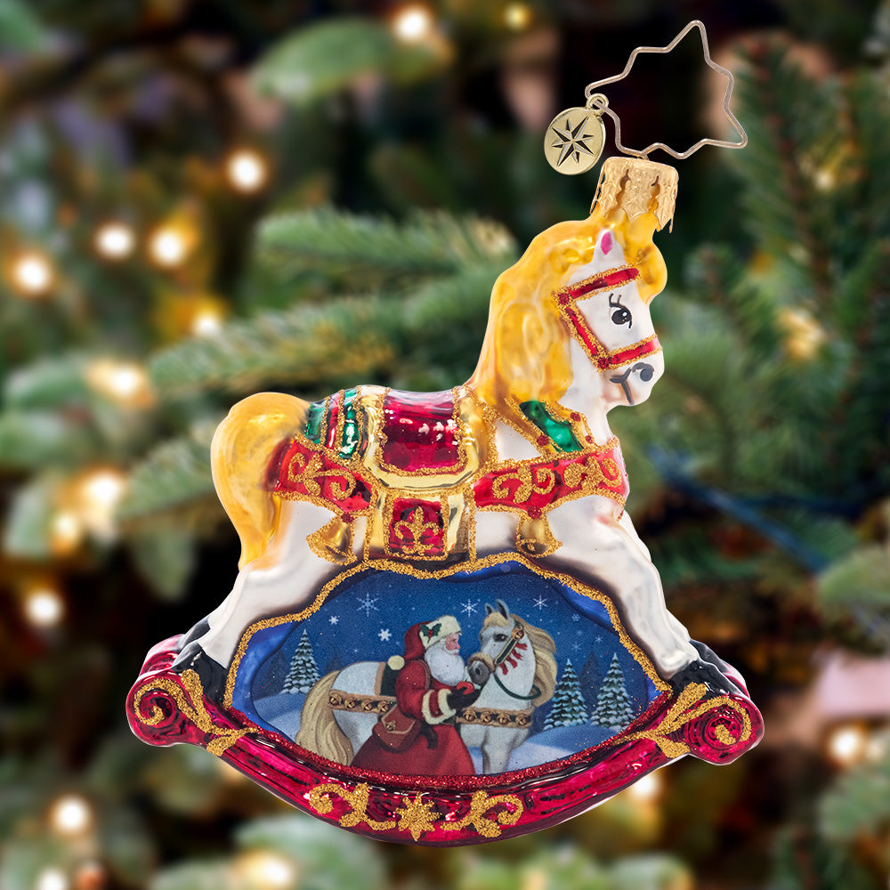 Ornament Description - Resplendent Rocking Horse Gem: Ornately decorated with a snowy scene of Santa and his noble steed, this ornament is a timeless and traditional piece to adorn your tree.
