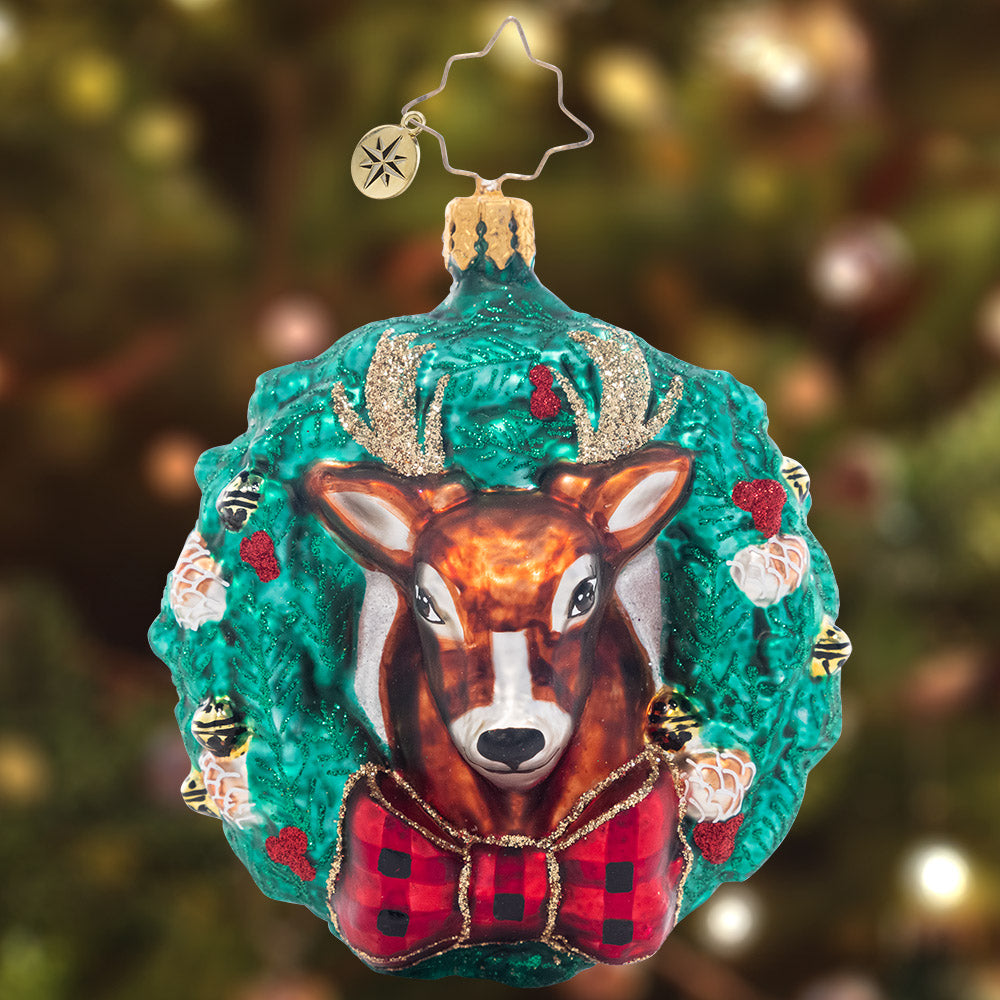 Ornament Description - Rustic Reindeer Wreath Gem: That's one dashing reindeer! Dressed to the nines in a checkered bowtie, this splendid stag makes the perfect centerpiece in a vibrant green wreath.