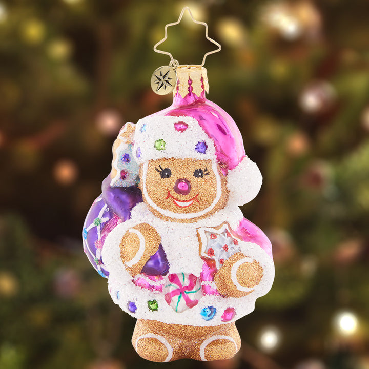 Ornament Description - Gingersnap Santa Gem: Meet Santa's sweet stand-in, Cookie Claus! This little gingerbread gem is as cute as a button, ready to help deliver Christmas treats to all the good little girls and boys.