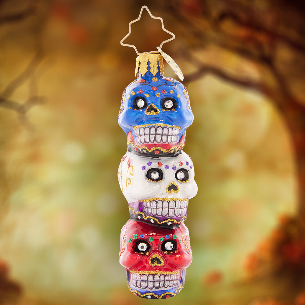 Ornament Description - Spooky Sugar Skulls Gem: These three sparkly skulls are a spooky stack to adorn your tree! Painted ornately to pay homage to the Day of the Dead, this is a unique and beautiful piece.