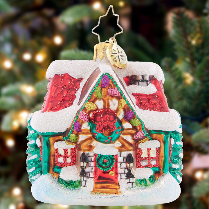 Ornament Description - The Coziest Cottage Gem: Covered in deep snow drifts, this little cottage is cozy warm on the inside. The perfect spot to warm up with some milk and cookies on Christmas Eve!