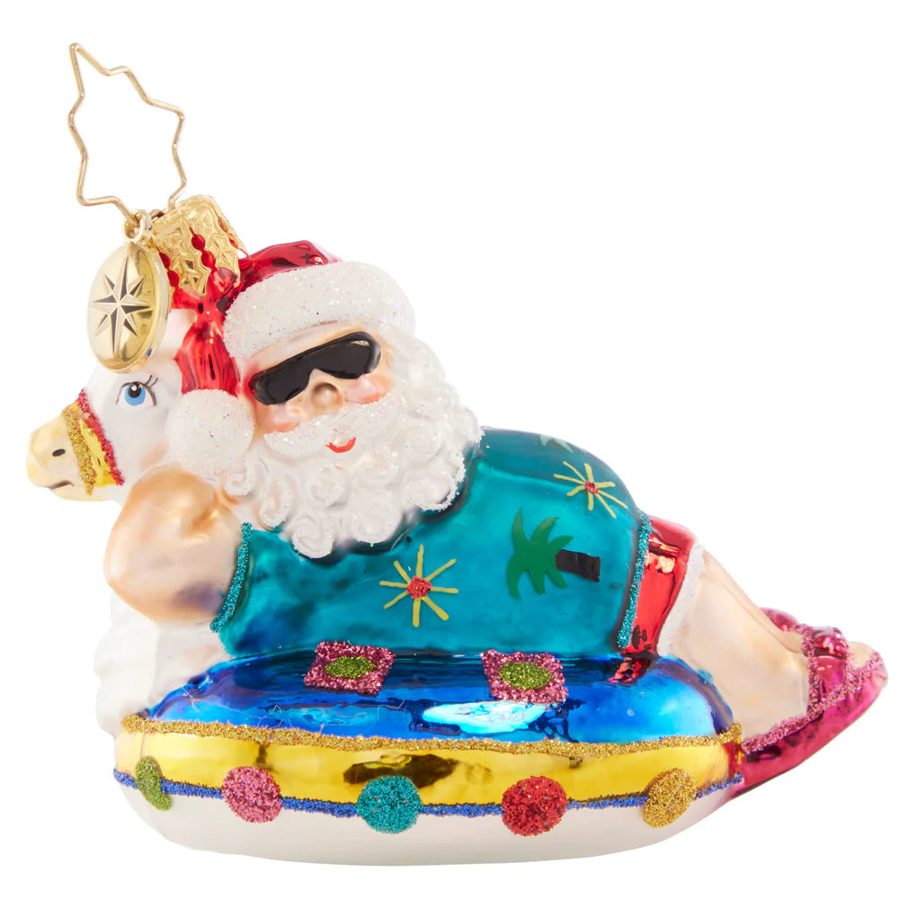 Ornament Description - Ho-Ho-Holiday in the Sun Gem: After a busy Christmas season, Santa is ready to rest and relax on his festive floatie.