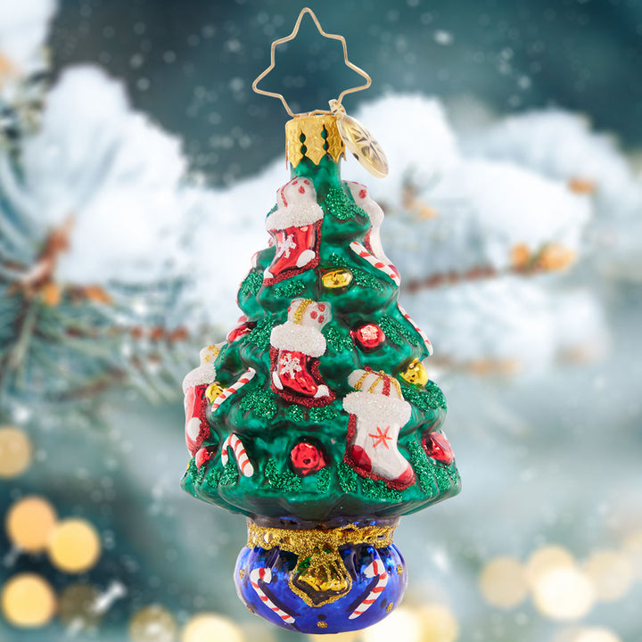 Ornament Description - Candy Cane Conifer Gem: This tasty tree is trimmed with candy canes and gift-stuffed stockings – what a cute little treat to celebrate the holidays!