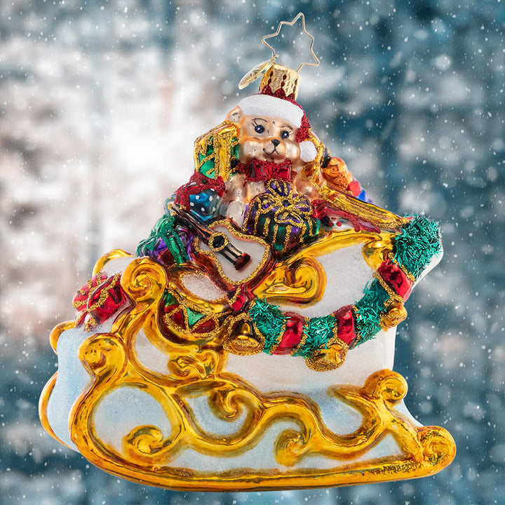 Ornament Description - Santa's Gilded Glider: Gilded with gold and abounding with glorious gifts, this sleigh is a special sight to see the night before Christmas.
