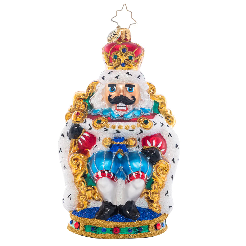 Ornament Description - At Home on the Throne: The nutcracker king is keeping court at the candy castle, sitting comfortably in a gilded throne. Add a regal touch to your tree with this stunning piece!