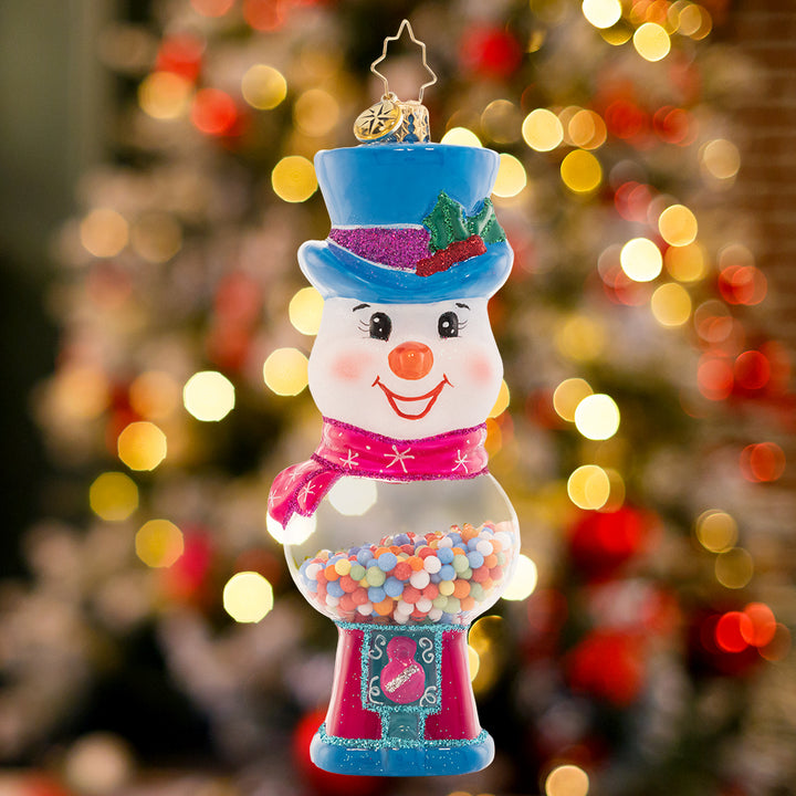 Ornament Description - Gumball Grins: This jolly, top-hat wearing snow friend doubles as a classic gumball machine, ready to add a whimsical pop to your tree.