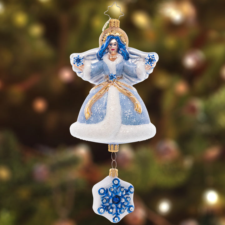 Ornament Description - Sapphire Snow Angel: This stunning snow angel is dressed in an icy, shimmering saphhire robe. She shines as a bright beacon of hope through the cold winter night.