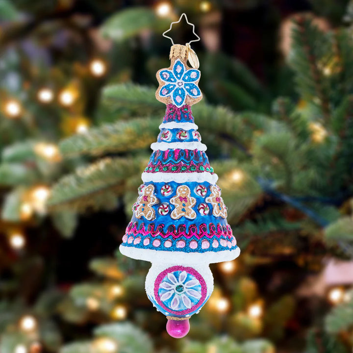 Ornament Description - The Sweetest Season: Trimmed with gingerbread men and topped with a snowflake-shaped Christmas cookie, this tree certainly is the sweetest spruce of the season.