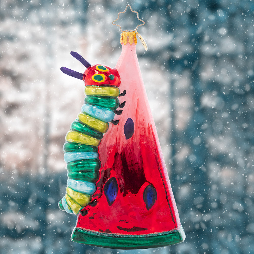 Ornament Description - Caterpillar Cravings: The Very Hungry Caterpillar is no different than us… It's impossible to resist the temptation of a juicy watermelon. Eric Carle's beloved character climbs his meal in persistent search for more goodies in this shimmery ornament.