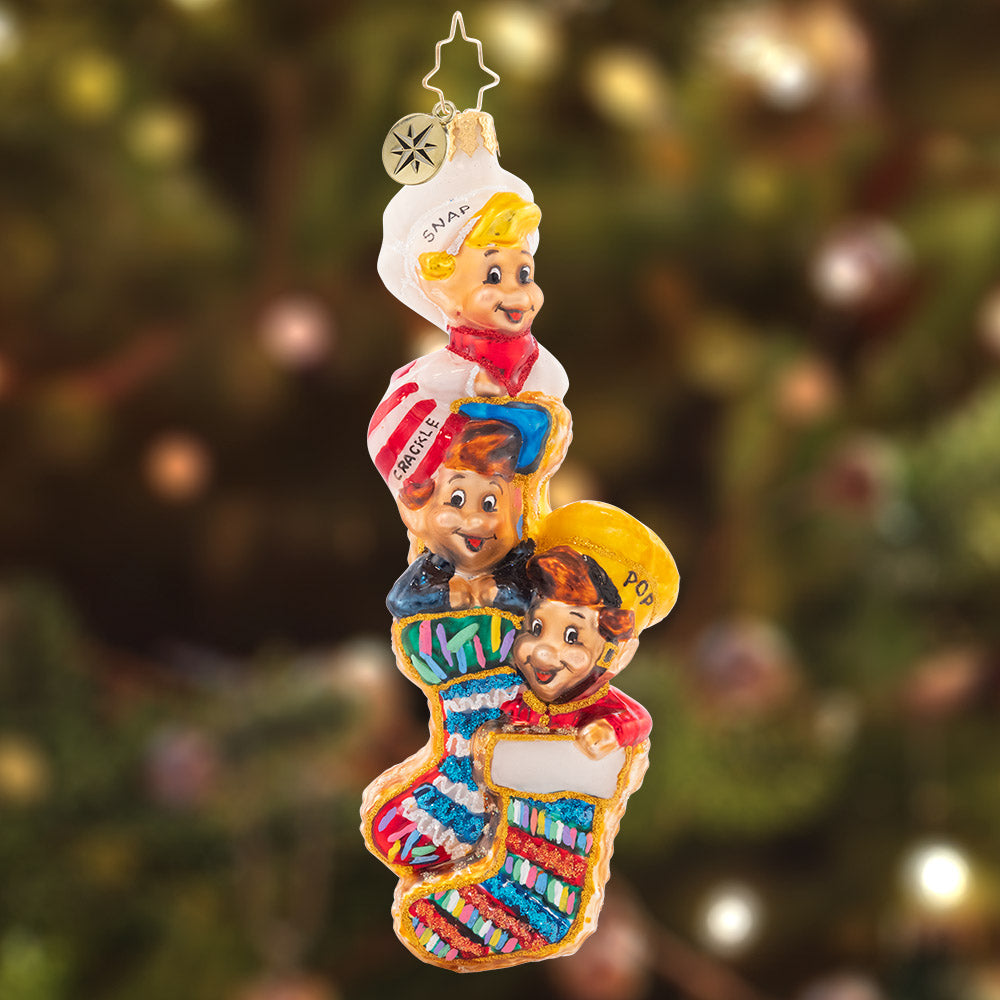 Ornament Description - Snappy Stocking Stuffers: Imagine waking up Christmas morning and finding Snap! Crackle! And Pop! In your stockings…. I wouldn't complain! For an added surprise, turn them around and find that the stockings are actually everybody's favorite snack: Rice Krispies Treats!