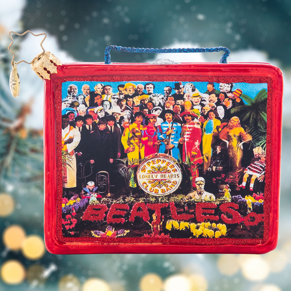 Ornament Description - Sgt. Pepper Lunch: The hottest lunchbox in the school cafeteria! This replica of a collector's item is its own cherished piece! This ornament miraculously features the album art for the iconic Sgt Pepper's Lonely Hearts Club Band in all its stunning detail.