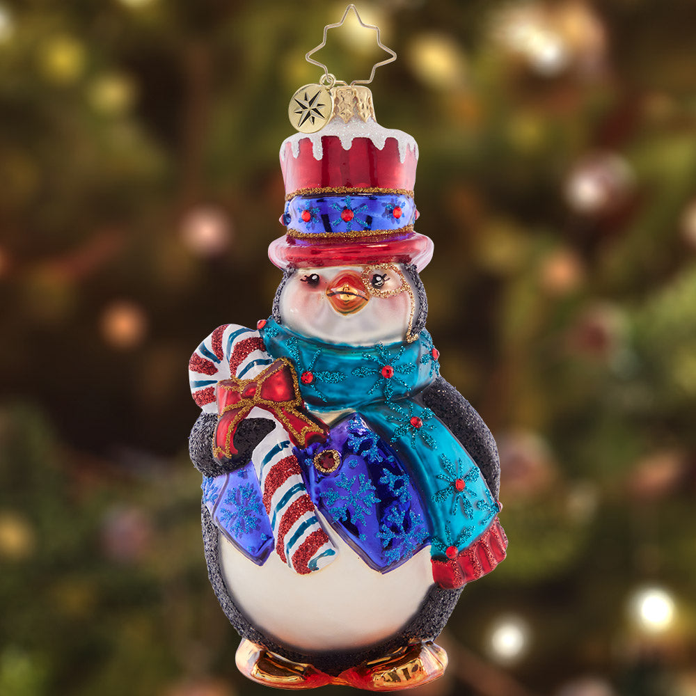 Ornament Description - Dapper Penguin: This wonderful winter waddler is certainly dressed for the weather, ready to go in his cozy scarf and top hat!