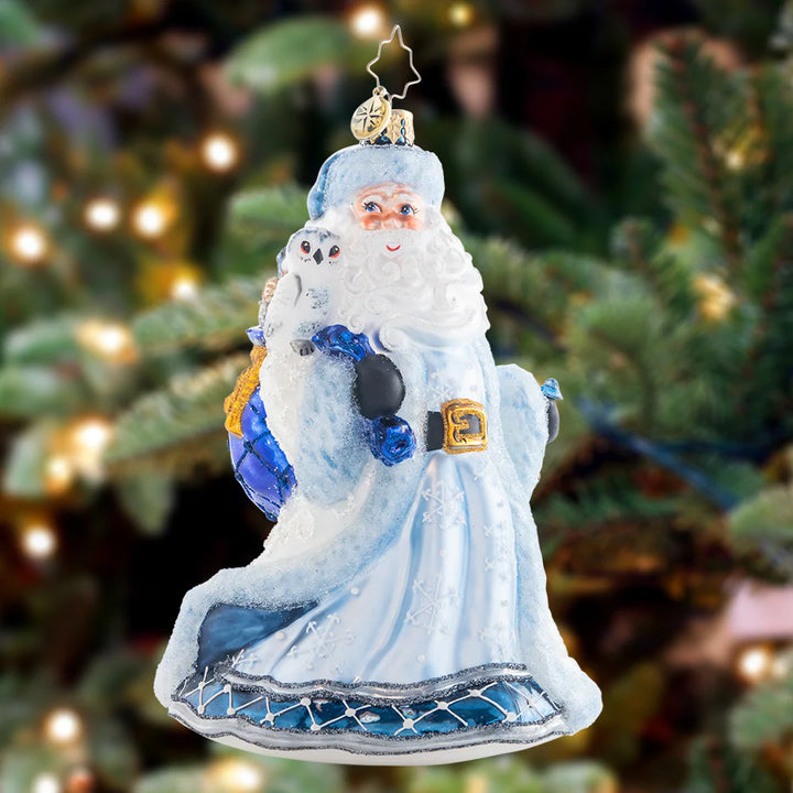 Ornament Description - Winter Wonderland Santa: Strutting in a winter wonderland…Santa strolls comfortably with his bejeweled staff and cozy ice-blue coat. His owl friend sits atop his shoulder to keep him company.