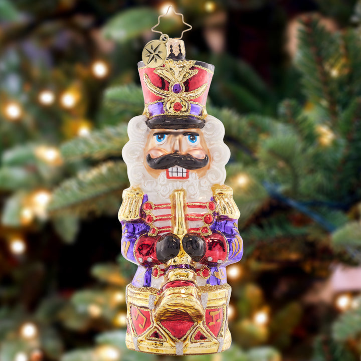 Ornament Description - Here Ye Here Ye: Fa-la-la-la-la! Prepared with his holiday horn and drum, this musical nutcracker is ready to put on a Christmas concert.