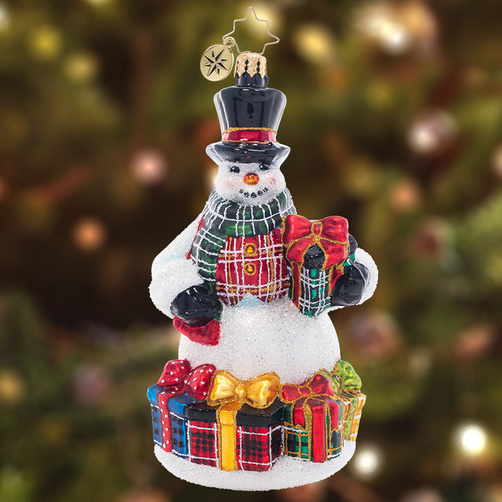 Ornament Description - Plaid Perfection: It's that time of year to wear the holiday plaid, to show it's more than a fad. With presents to match, this snowman is quite the dashing catch!