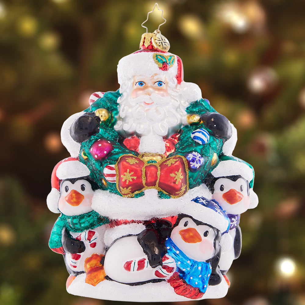 Ornament Description - Polar Portrait: Surrounded by a plethora of playful penguins and a joyful wreath, Santa is feeling festive and ready to celebrate the holiday season!