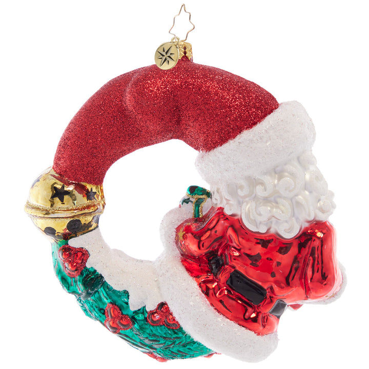 Back - Ornament Description - Christmas Wishes Santa Wreath: Ready to celebrate another Christmas holiday with a sweet treat and a gorgeous gift, Santa is looking especially cheerful, wrapped as a wondrous wreath.