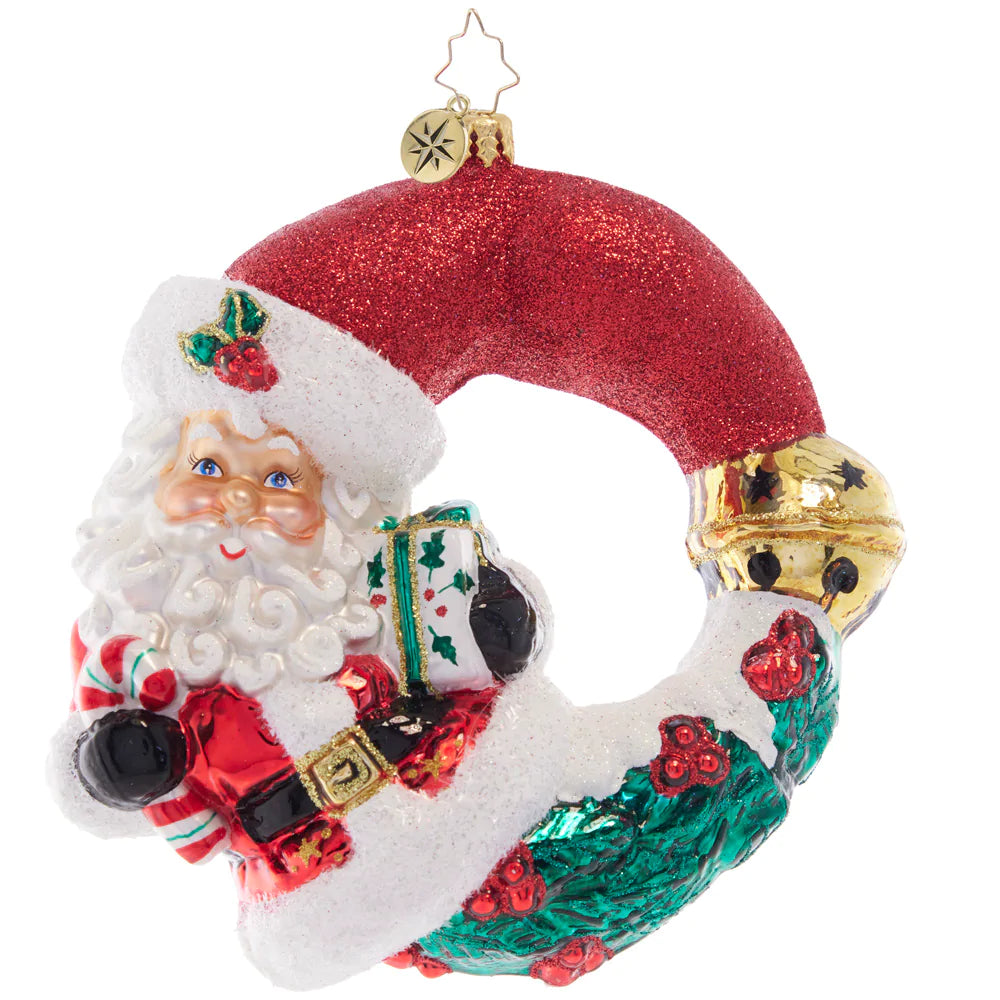 Front - Ornament Description - Christmas Wishes Santa Wreath: Ready to celebrate another Christmas holiday with a sweet treat and a gorgeous gift, Santa is looking especially cheerful, wrapped as a wondrous wreath.