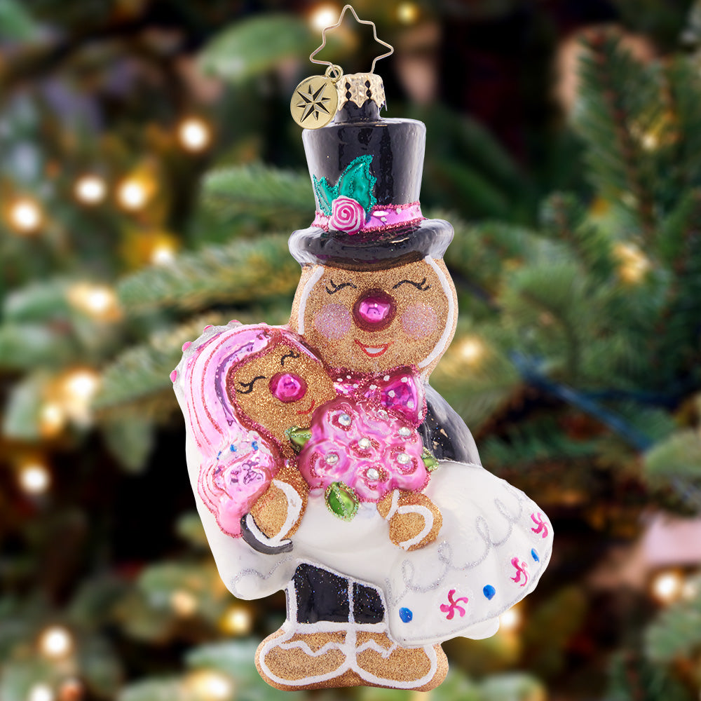 Ornament Description - Love is Sweet: You may now kiss the cookie! These gingerbread newlyweds are happy as can be, ready to go on their sugary-sweet honeymoon!