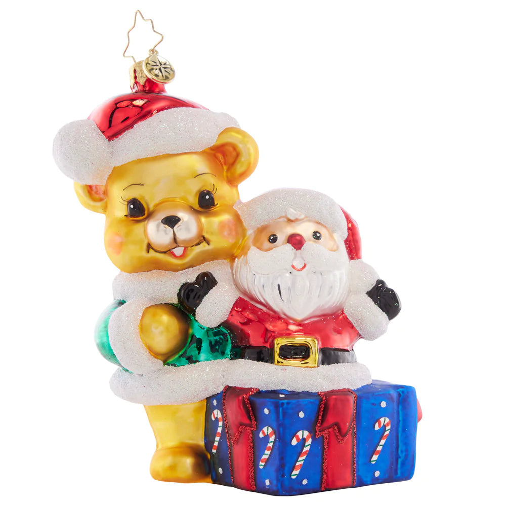 Front - Ornament Description - Present For Ted E. Bear: Surprise! This sweet teddy bear presents the perfect Christmas gift – a jolly Santa Claus filled with holiday cheer.