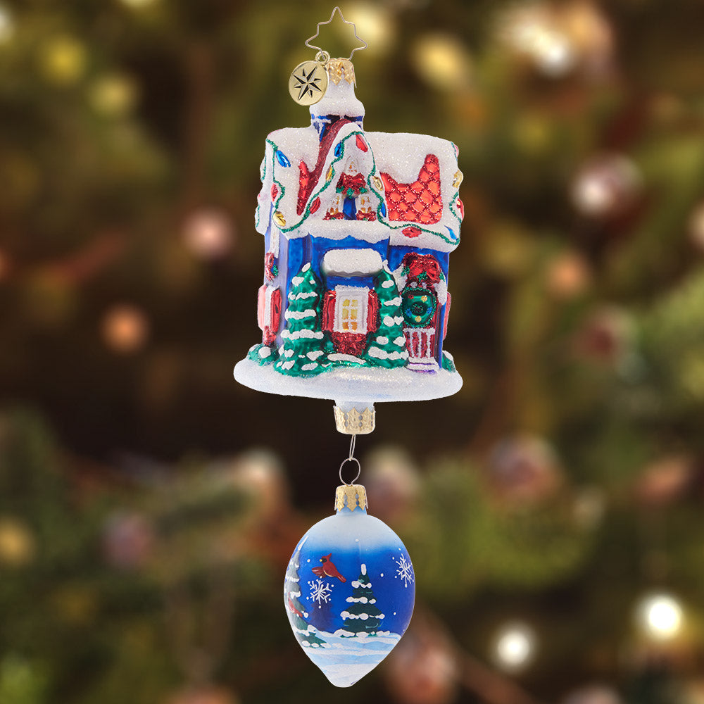 Ornament Description - Snowdrop Cottage: This cute little cottage is covered in Christmas lights and fresh snow. Featuring a beautiful winter scene on a drop-shaped addition dangling below, this ornament is a special piece to add to your collection.