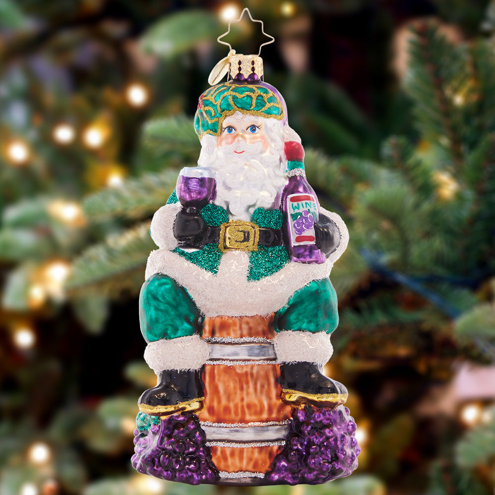 Ornament Description - Time for Fine Wine Santa: Sip-sip-hooray! Sommelier santa sits atop a wine barrel and samples a delicious vintage vino to celebrate another wonderful holiday season.