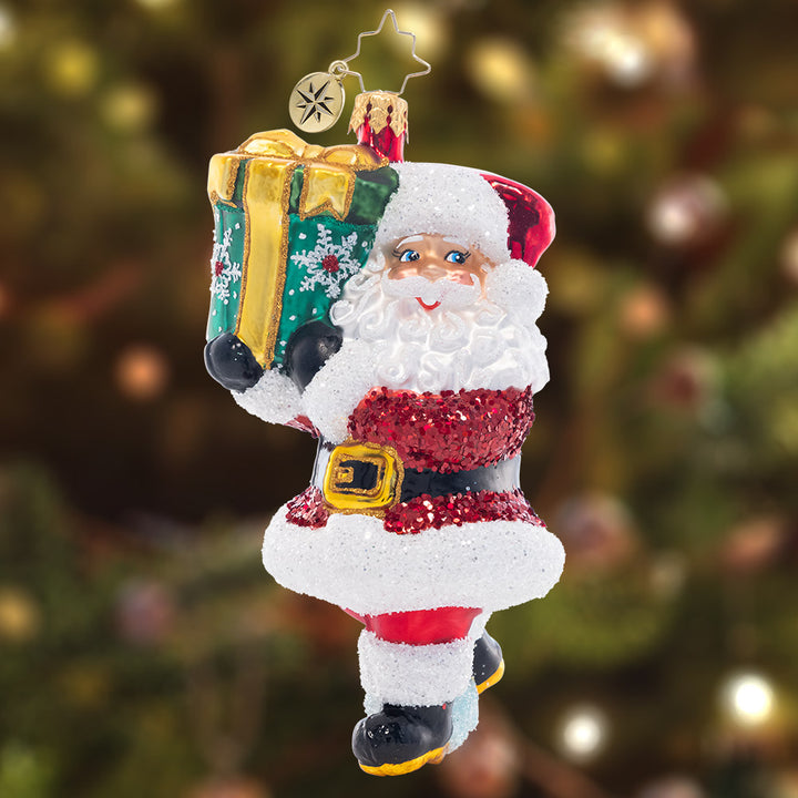 Ornament Description - TipToe To The Tree: Santa must be sneaky in order to get this gigantic gift under the tree without waking anyone up! This merry ornament is an adorable addition to your collection.