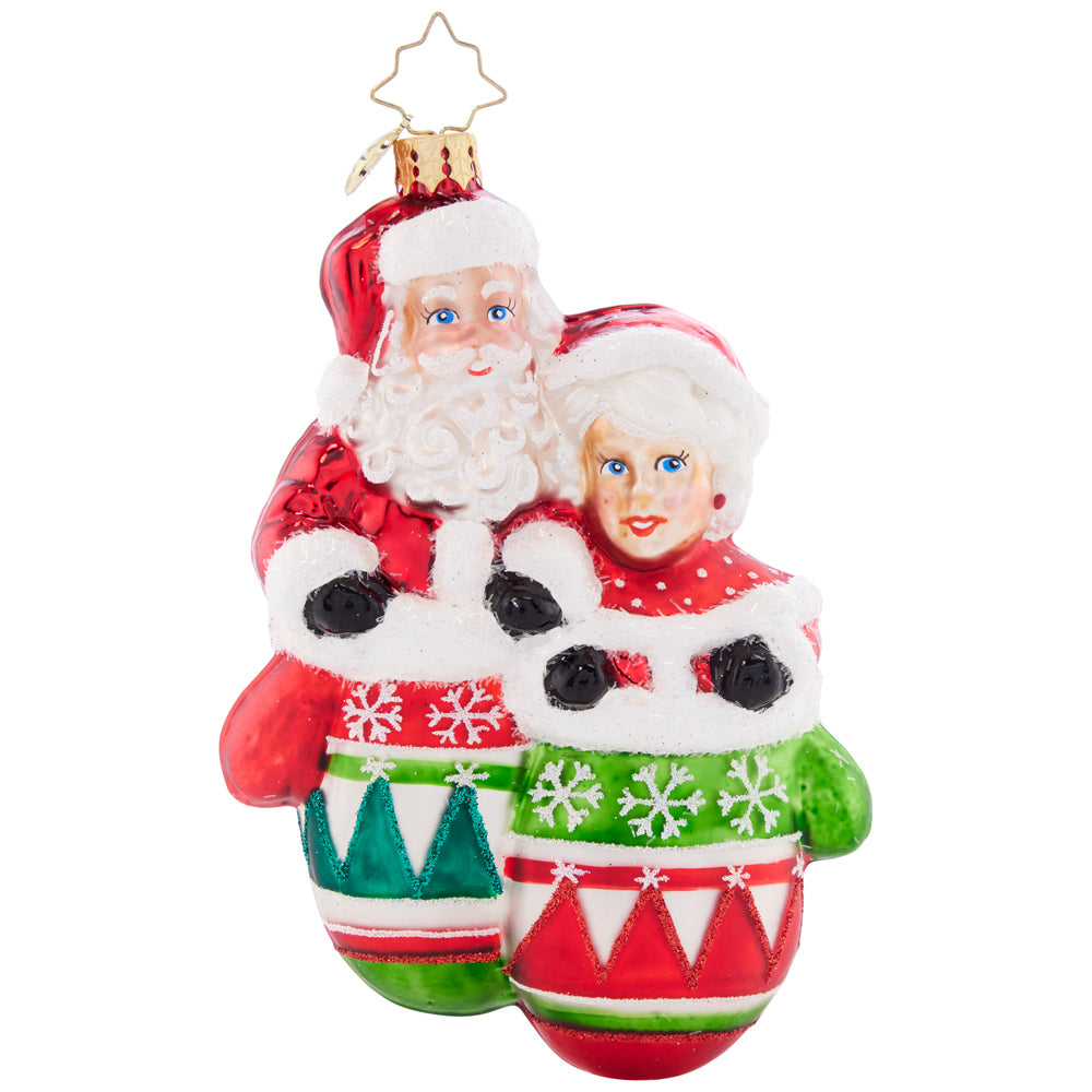Front - Ornament Description - Christmas Couple: Mr. and Mrs. Claus are sure looking smitten, all cozy warm in a pair of mittens. With classic Christmas colors and detailed decoration, this wonderful ornament elicits elation.