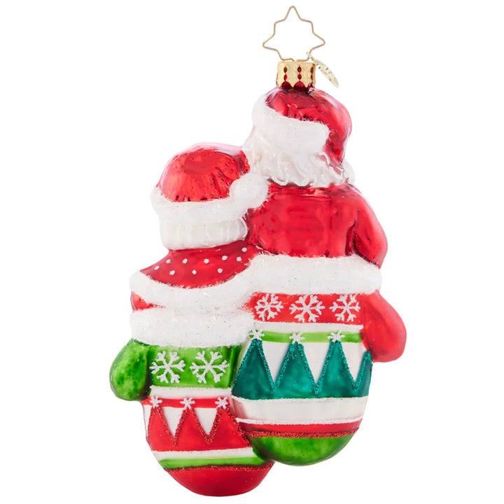 Back - Ornament Description - Christmas Couple: Mr. and Mrs. Claus are sure looking smitten, all cozy warm in a pair of mittens. With classic Christmas colors and detailed decoration, this wonderful ornament elicits elation.