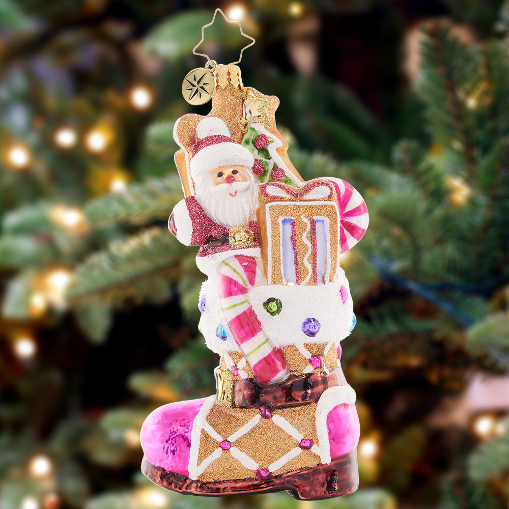 Ornament Description - Treat Yourself Boot: This festively-frosted gingerbread boot is filled to the brim with sweet treats and surprises, baked with love by Santa himself.