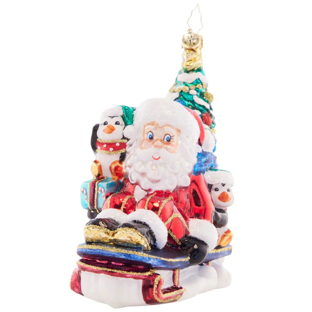 Front - Ornament Description - Christmas Getaway: Perfectly prepared with a trimmed tree, a sack of presents, and his trusty penguin pal, Santa zooms by in his speedy sled. He's got everything he needs for a cheer-filled Christmas!