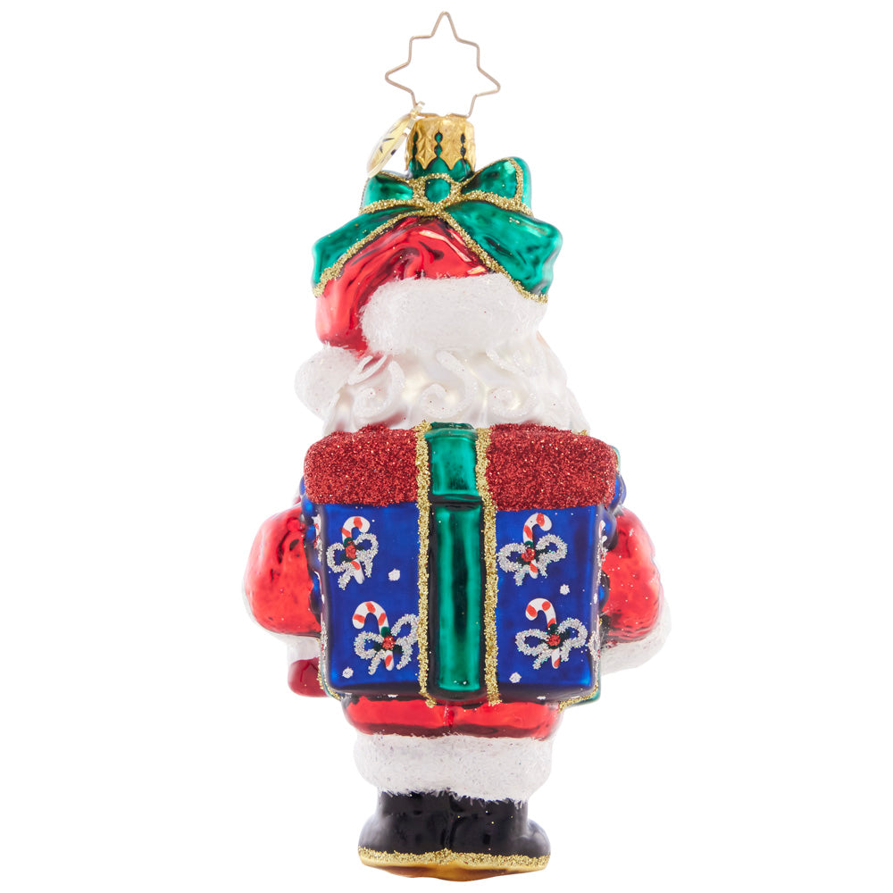 Back - Ornament Description - Santa Surprise: Santa is boxed up and topped with a bow, the greatest gift to give a friend or adorn your own tree.